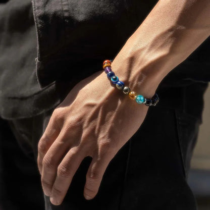 Man wearing a ZARAGRACE 7 Chakra bracelet with Evil Eye and Gloss Onyx beads, designed to attract positive energy, love, and wealth