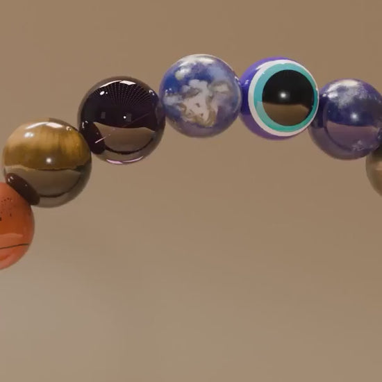 Close-up video of ZARAGRACE chakra healing bracelet rotating under soft lighting, showcasing colorful beads, Evil Eye charm, and Gloss Onyx for spiritual energy and manifestation.